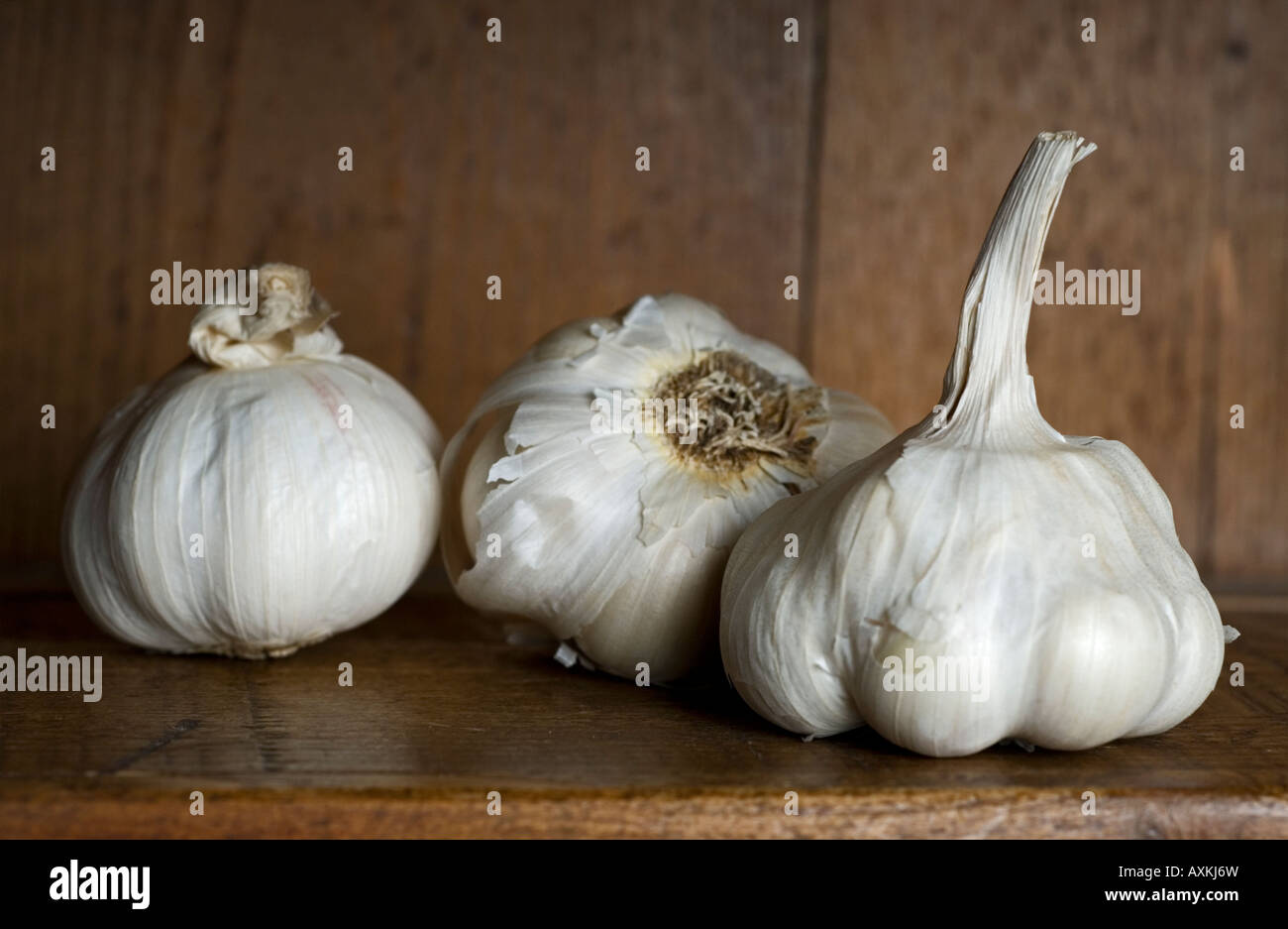 Stock photo of Garlic cloves on a wooden shelf in a Kitchen Stock Photo