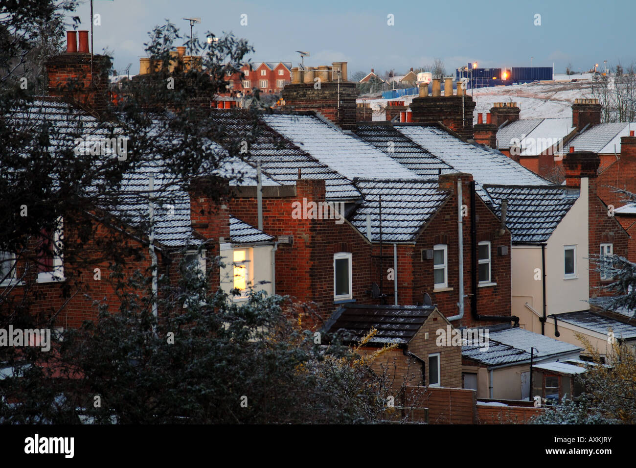 Backs of City Terraced houses at dusk in Winter Snow Stock Photo