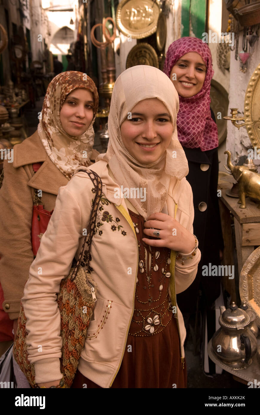 Three young Libyan women in the copper souq of the old town or medina, Tripoli, Libya, north Africa. Stock Photo