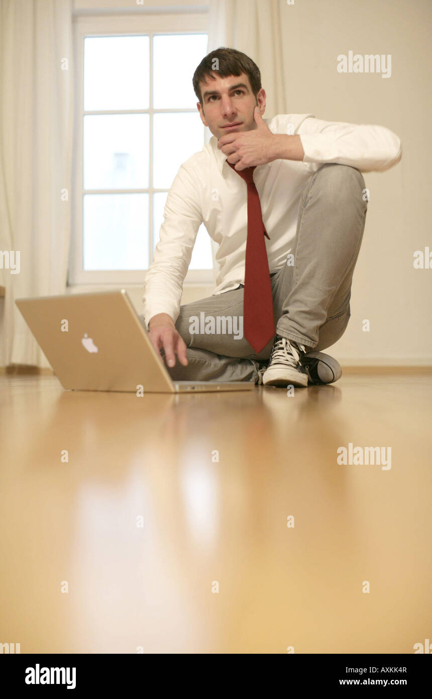 Symbols of application A young man in front of his laptop Stock Photo