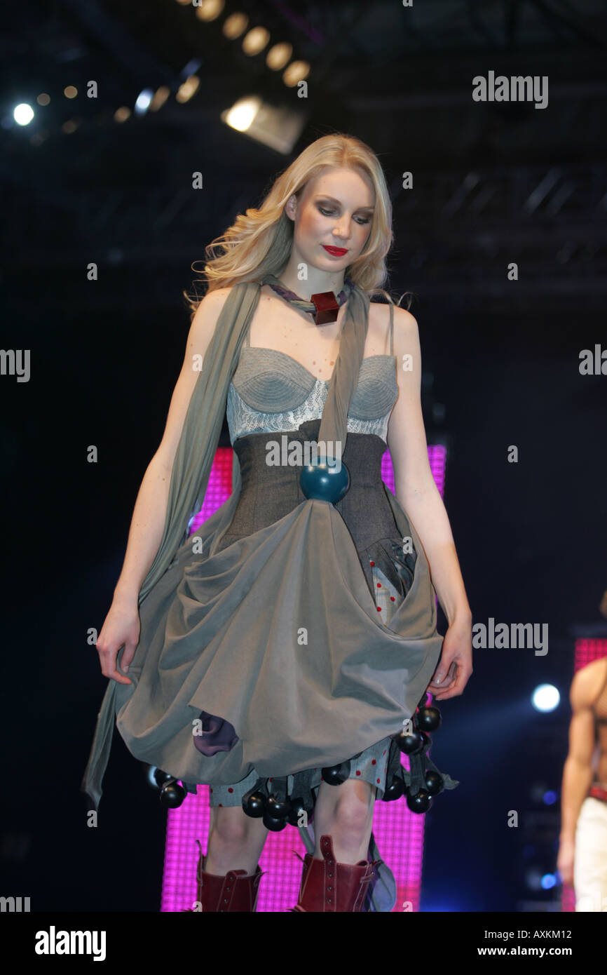 Model wearing grey dress with black ball trim and outsize bag at the Clothes Show NEC Birmingham December 2005 Stock Photo