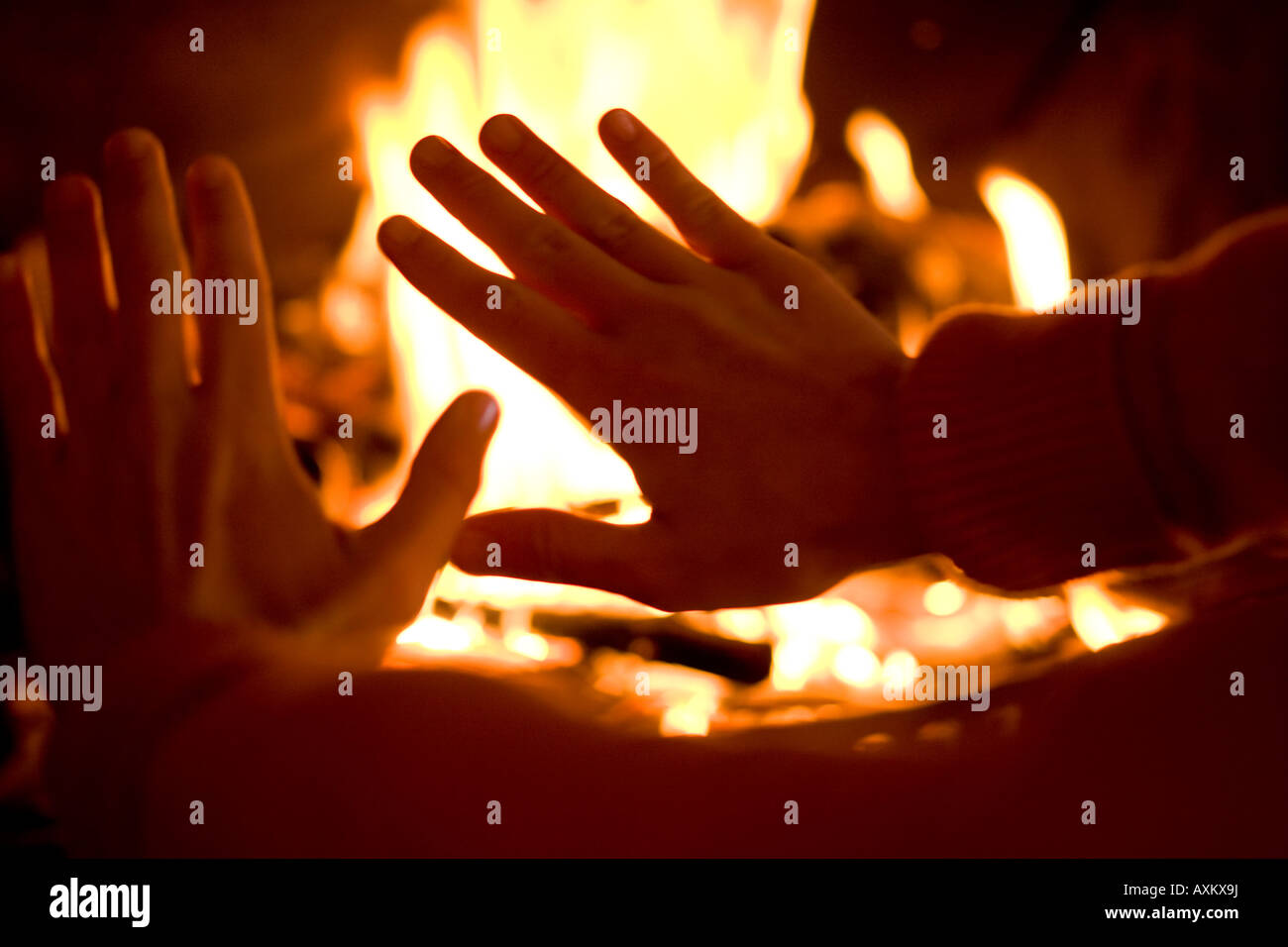 Person warming their hands over a fire Stock Photo Alamy
