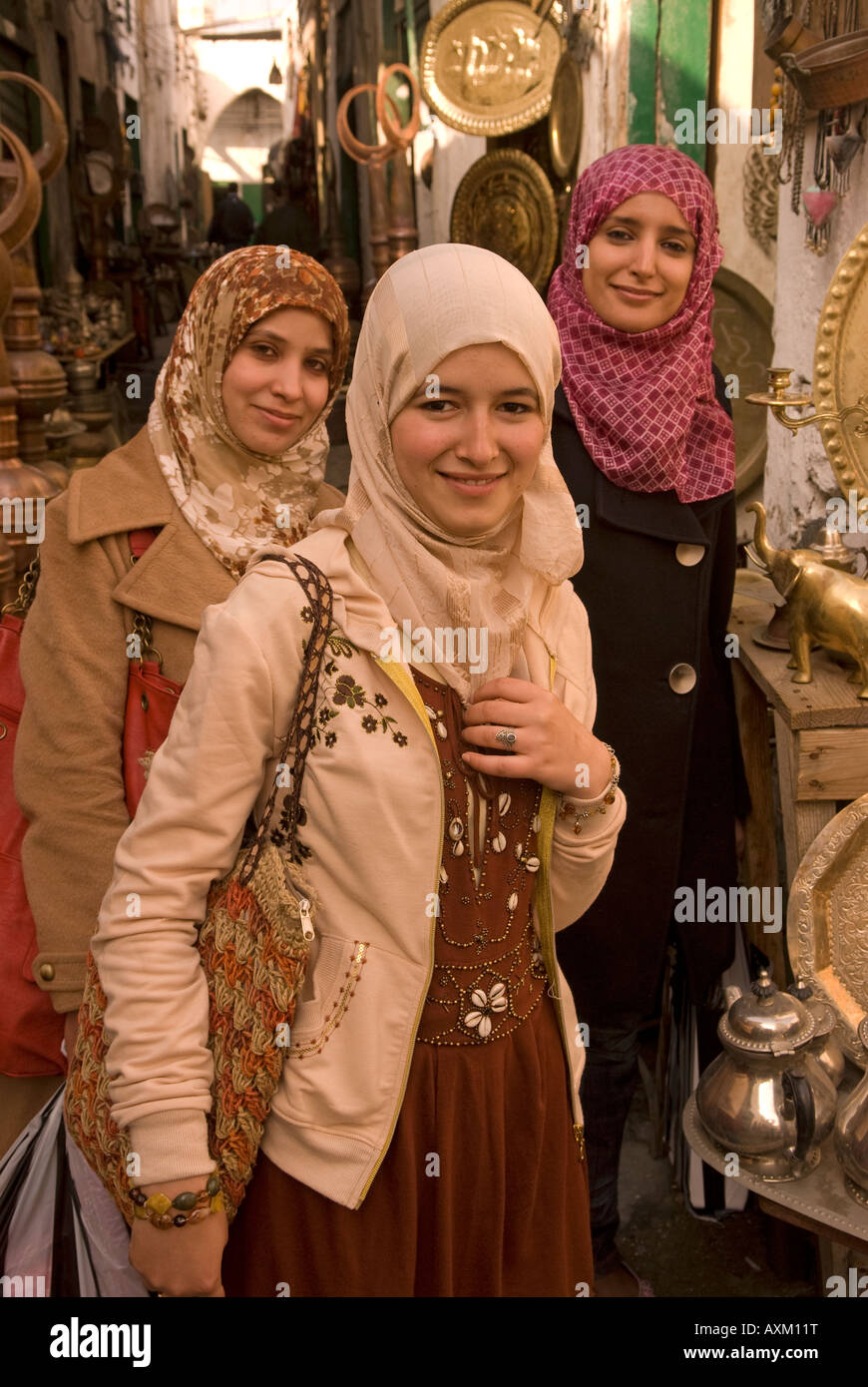 Three young Libyan women in the copper souk of the old town or medina, Tripoli, Libya. Stock Photo