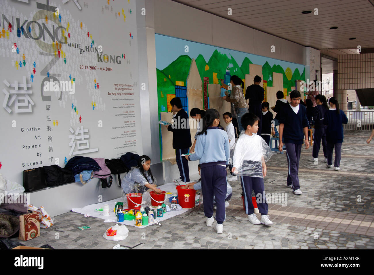 Hong Kong school art class painting murals on a wall of ...