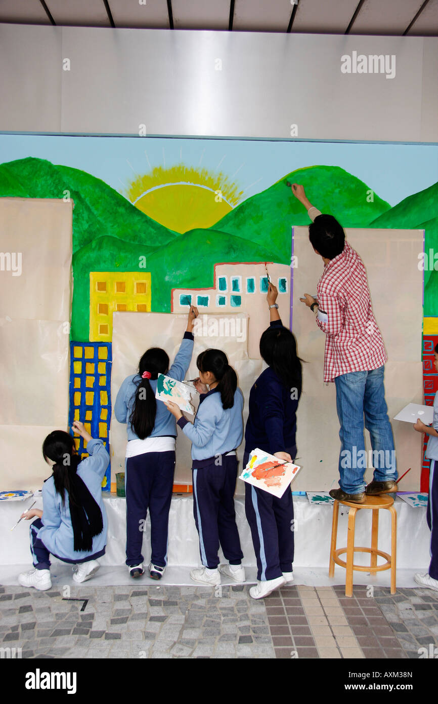 Hong Kong school art class painting murals on a wall of the Museum of