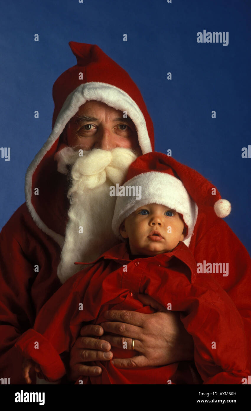 Santa Claus and his little apprentice. Father Christmas, Père Noël and his little assistant. Paire Noël. Stock Photo