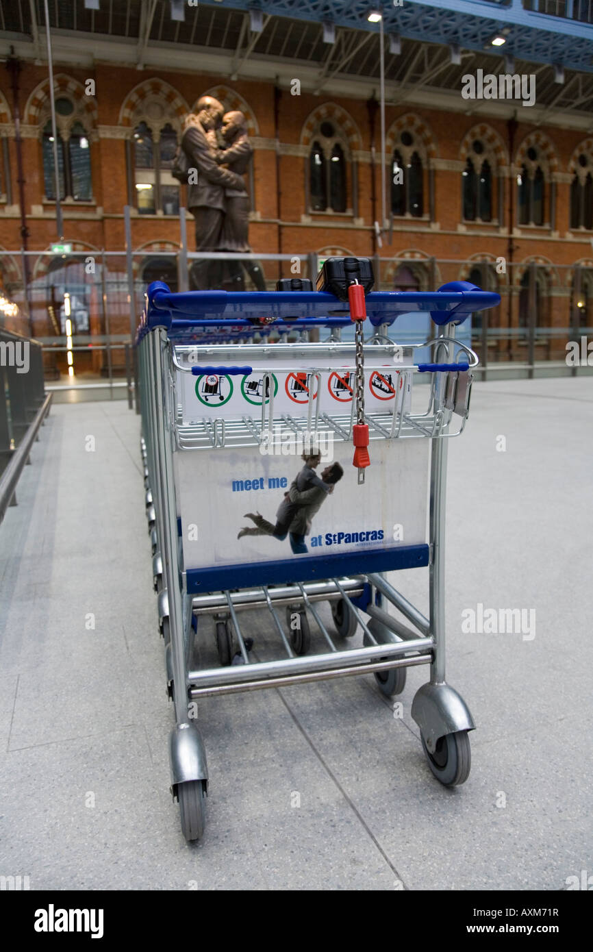 Baggage trolleys and Paul Day statue of lovers at Kings Cross Saint
