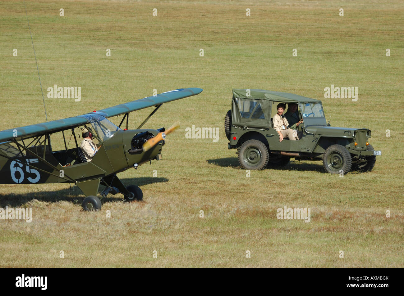 Old Piper J-3 Cub (L-4) plane anf famous Jepp car used during WWII in Europe by us army. Stock Photo