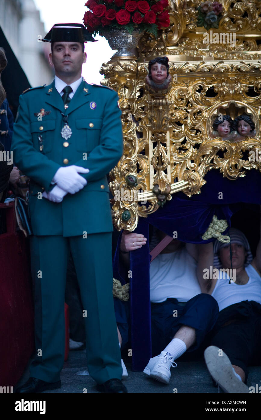 Civil Guard escorting a float and float bearers on a break, Holy Week 2008, Seville, Spain Stock Photo