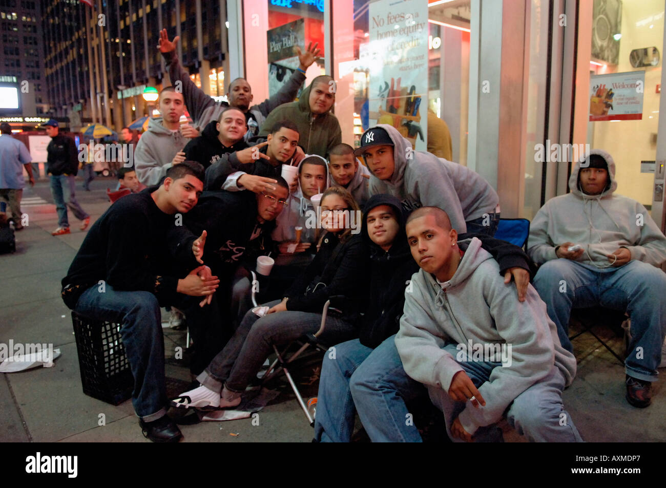 Youths pose while waiting in line to by newly released Air Jordan sneakers in front of FootAction store Stock Photo