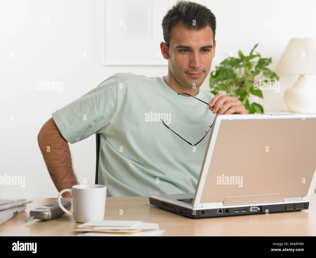 Man using laptop at table Stock Photo