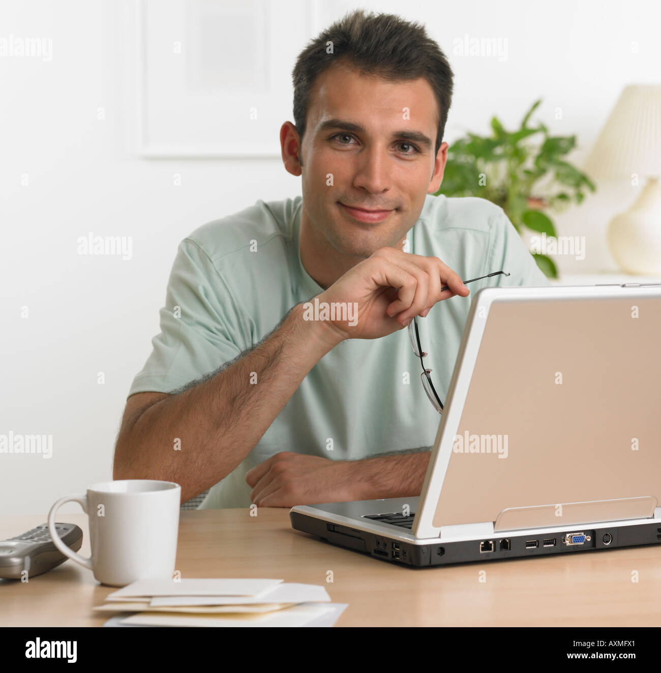 Man using laptop at table Stock Photo