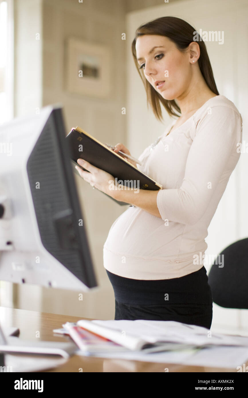 Pregnant woman in office Stock Photo Alamy