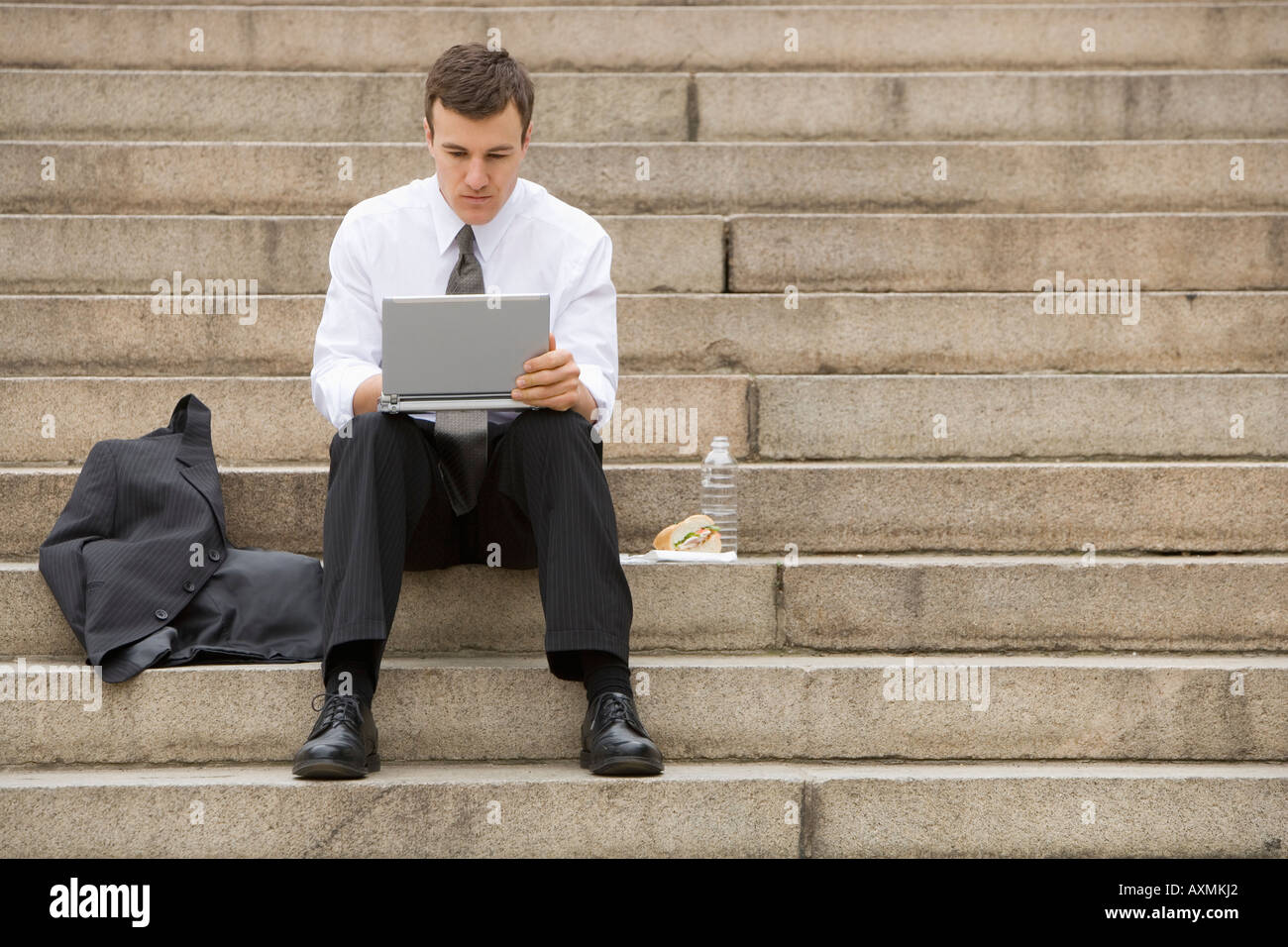 Businessmen sitting on stairs hi-res stock photography and images - Alamy