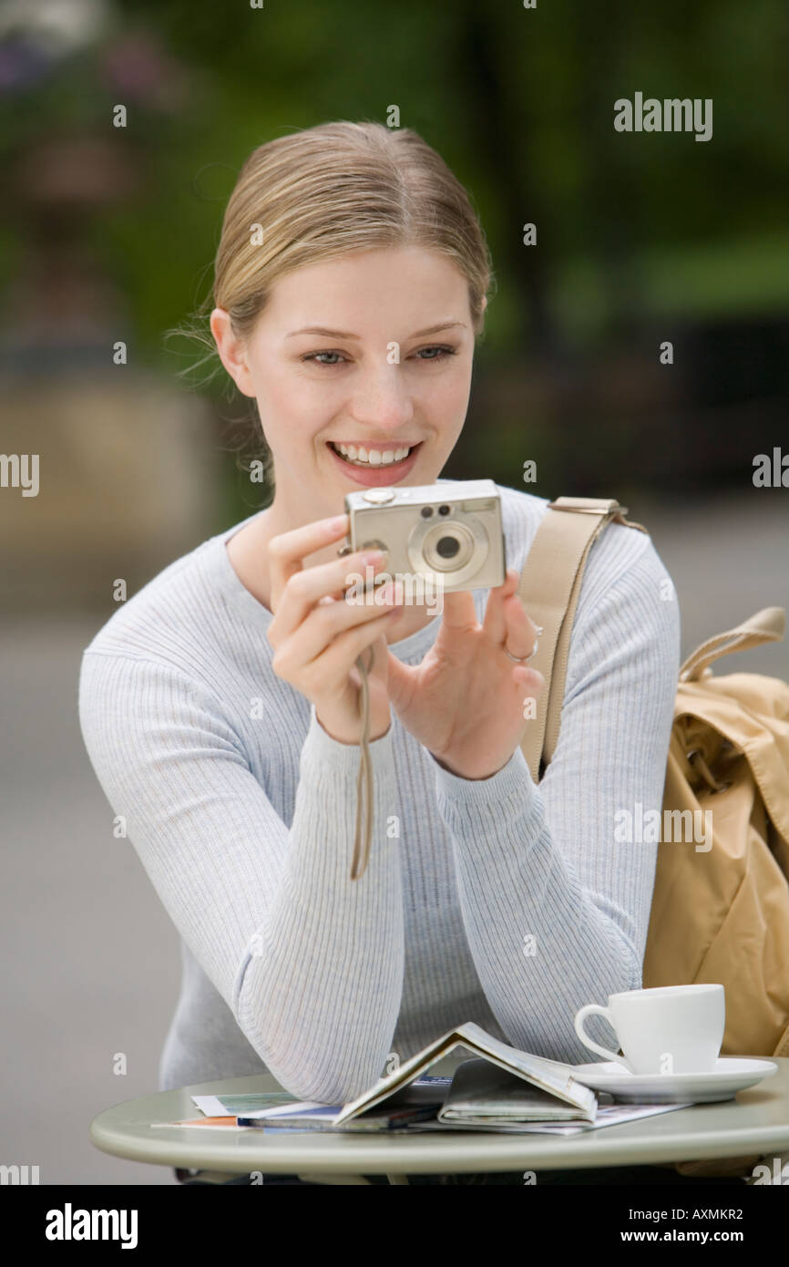 Portrait of smiling young tourist taking photos with camera hi-res ...