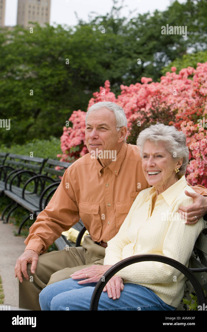 Senior couple sitting on park bench Stock Photo