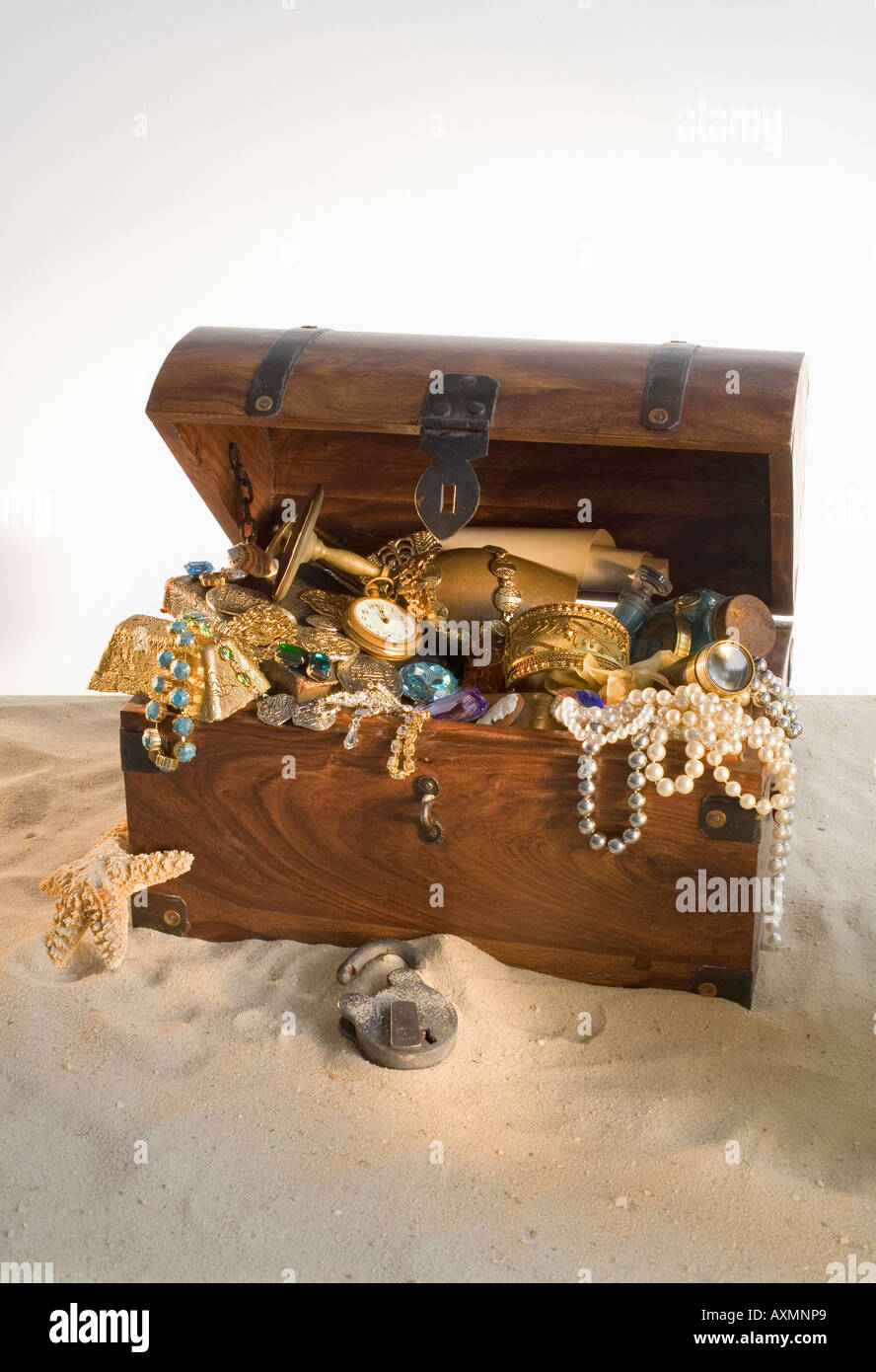 Wooden chest overflowing with treasure Stock Photo - Alamy