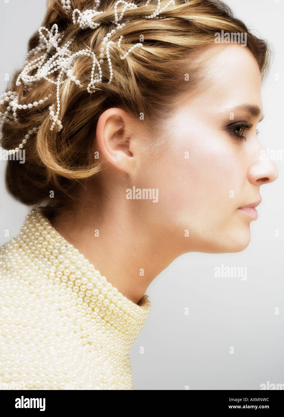 Profile of woman with small pearls in hair Stock Photo