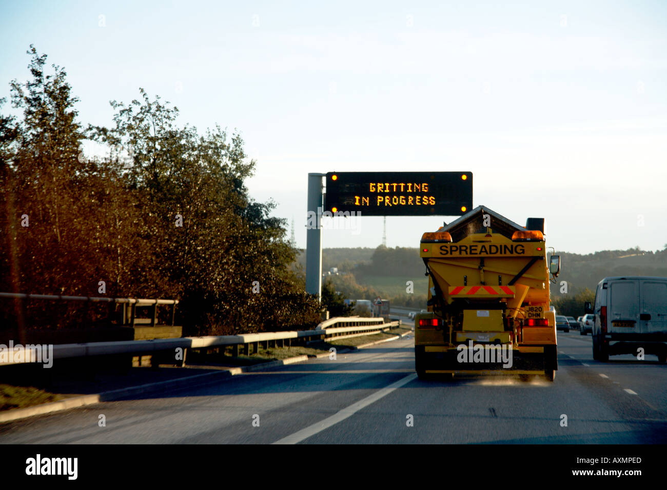 Gritting Lorry on M1 Motorway passing warning matrix sign Stock Photo