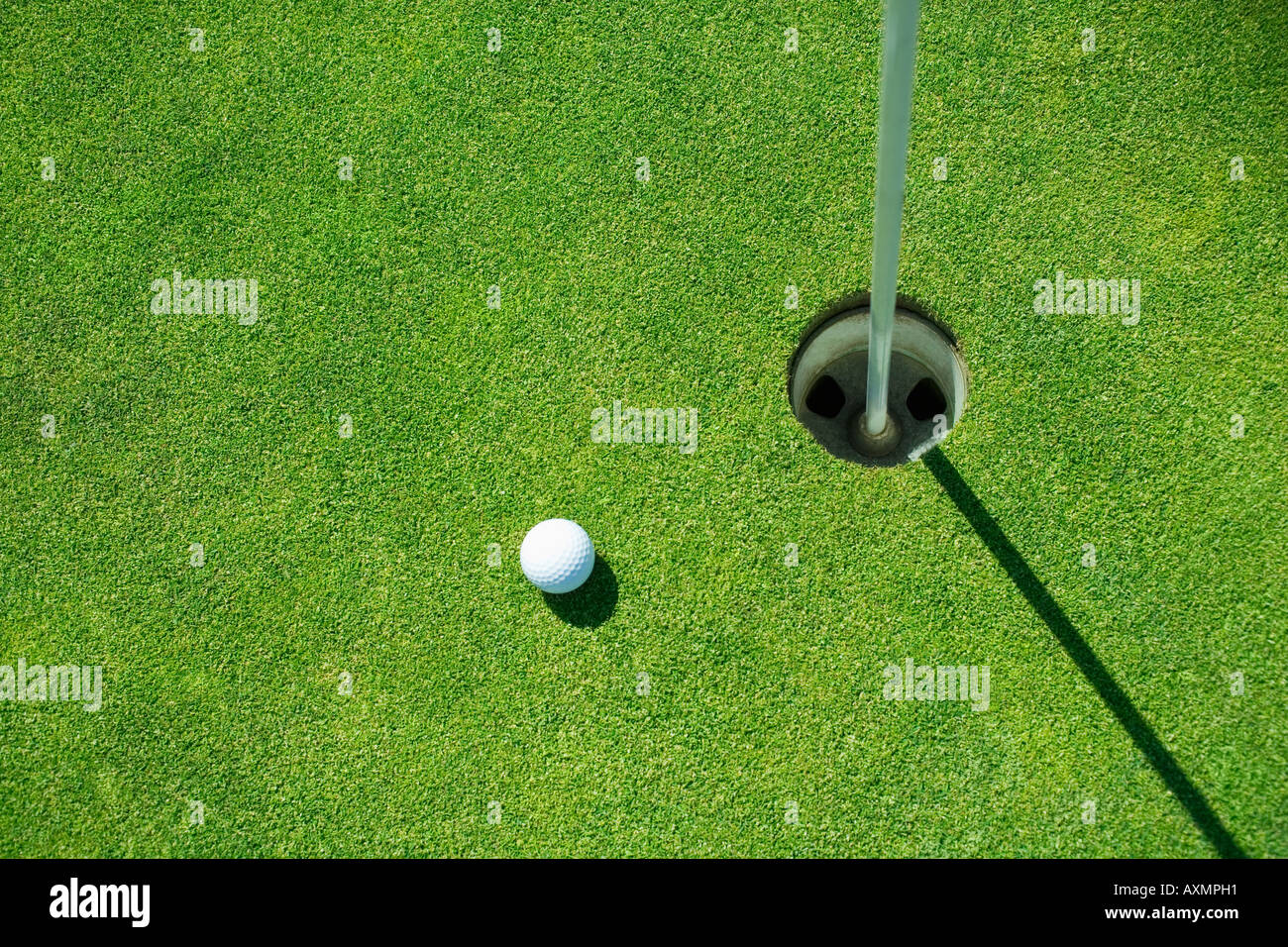 Golf ball near cup on putting green outdoors Stock Photo Alamy