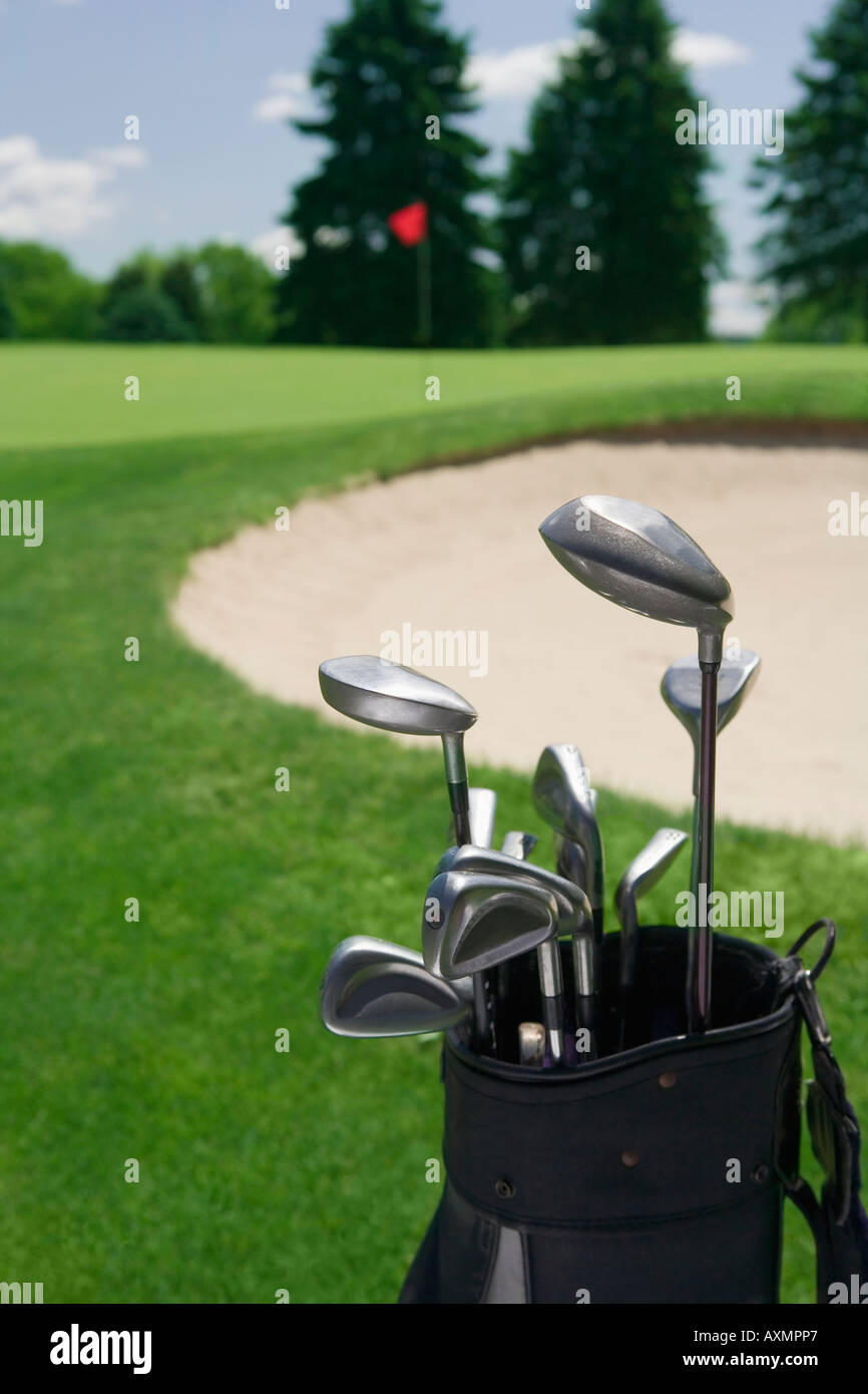 Golf clubs with course and sand trap in distance Stock Photo Alamy