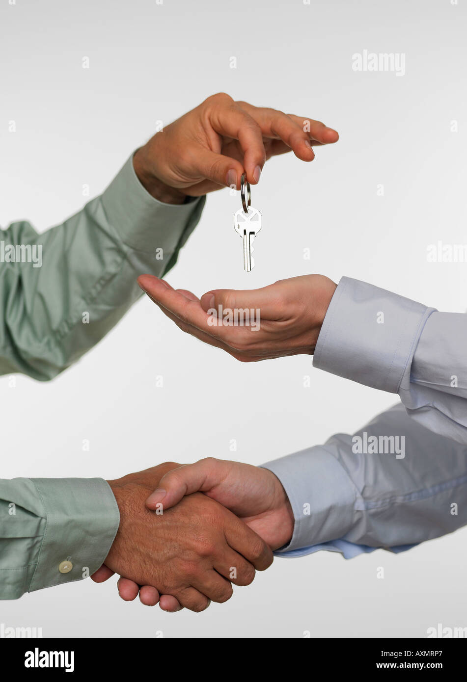 Two men closing deal and handing over keys Stock Photo