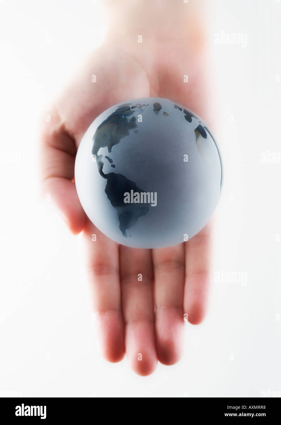 Hand in hand holding a globe hi-res stock photography and images - Alamy