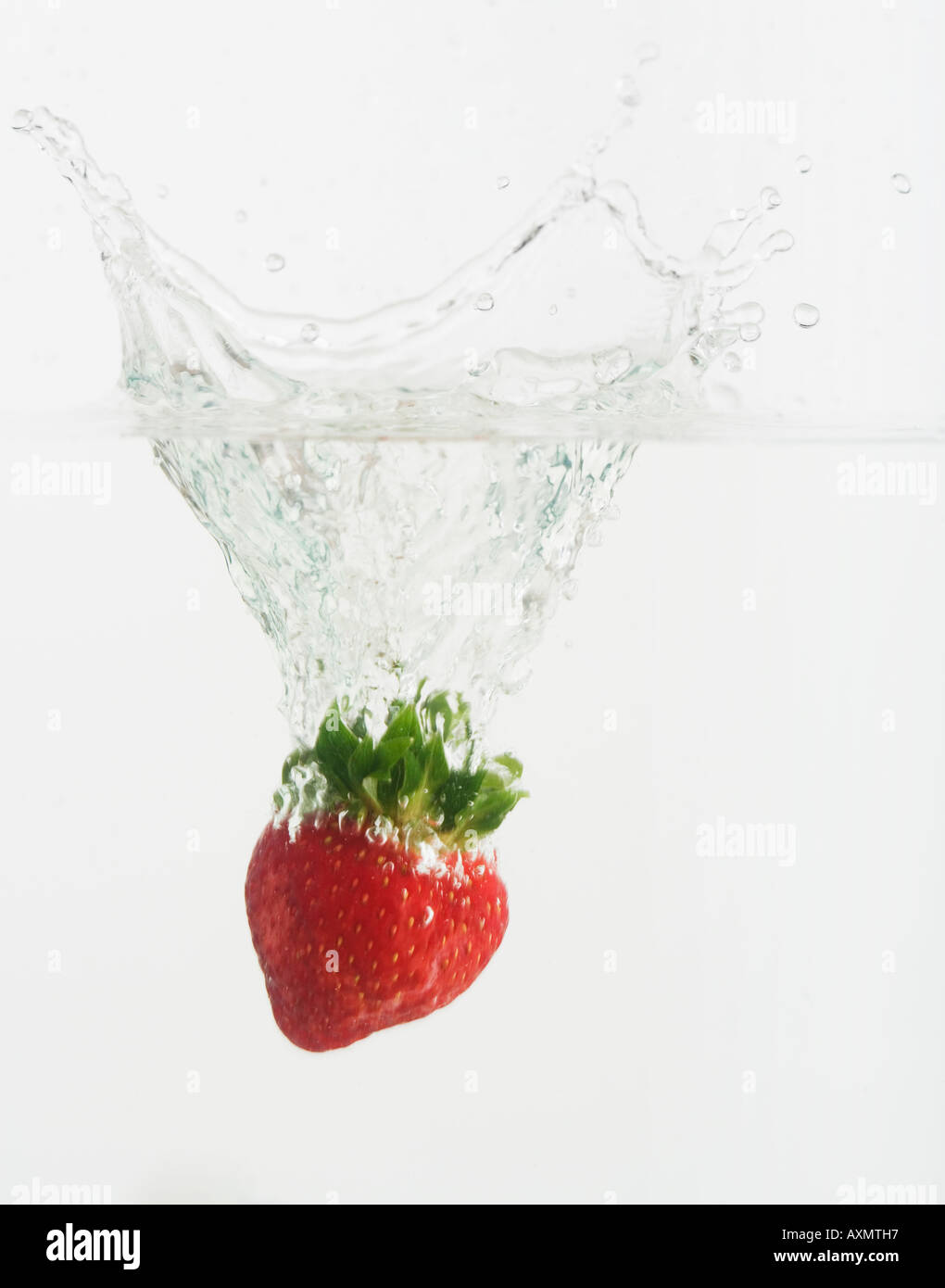 Strawberry dropped into water Stock Photo