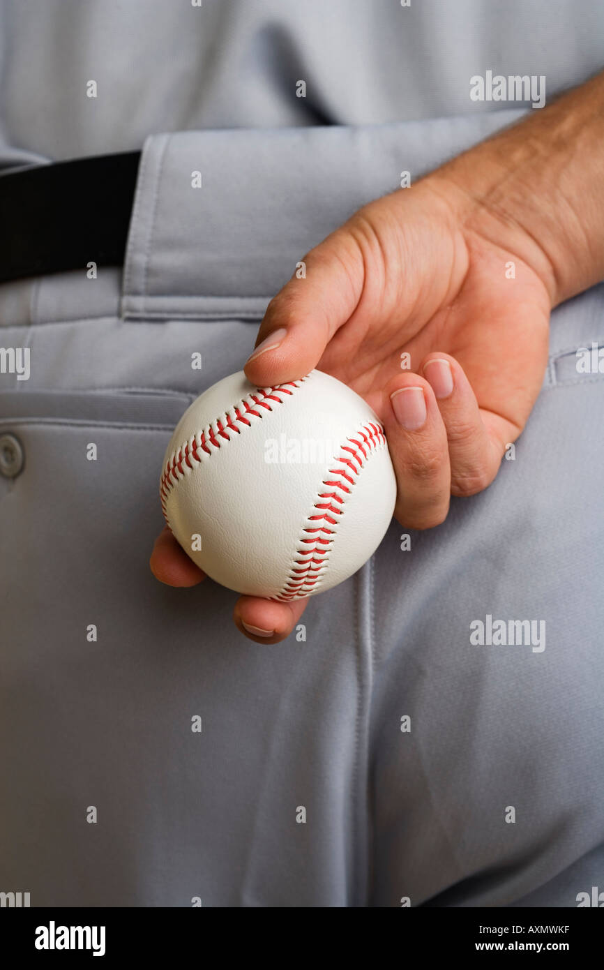 Close up baseball pitcher holding baseball behind back Stock Photo Alamy