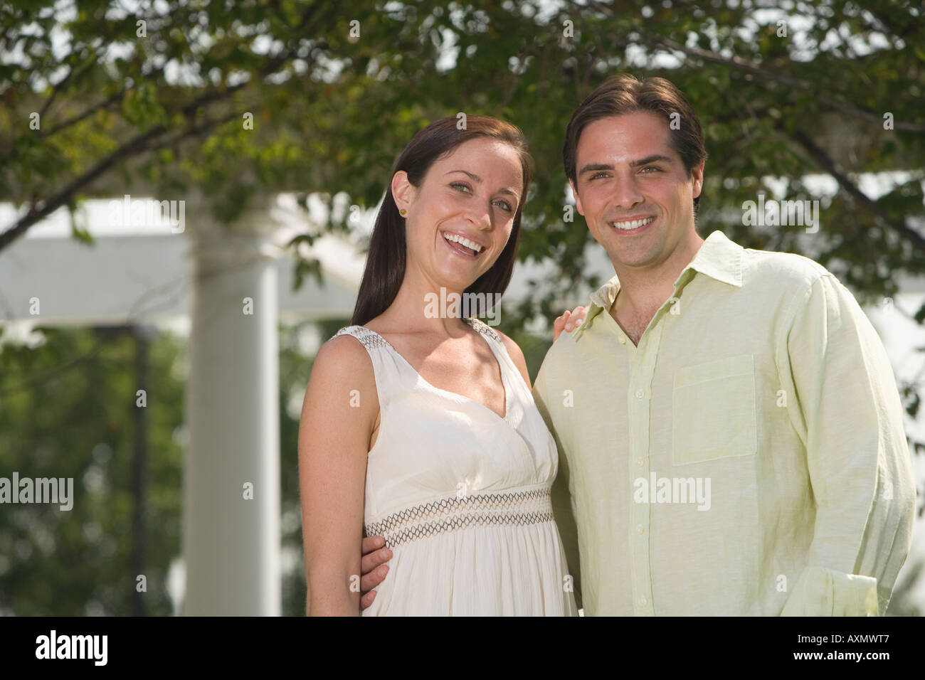 Couple hugging and smiling outdoors Stock Photo