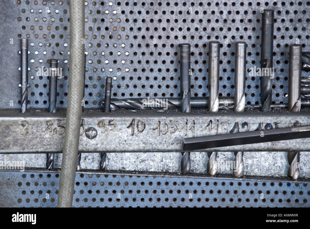 Stock photo of different sizes of drill bits stored next to an