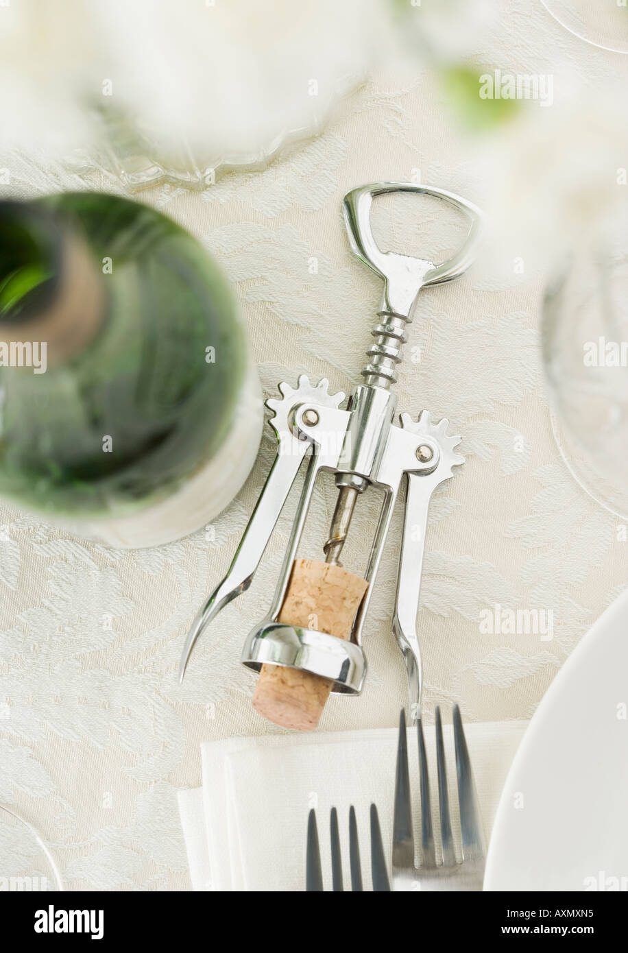 Table setting with wine and corkscrew Stock Photo