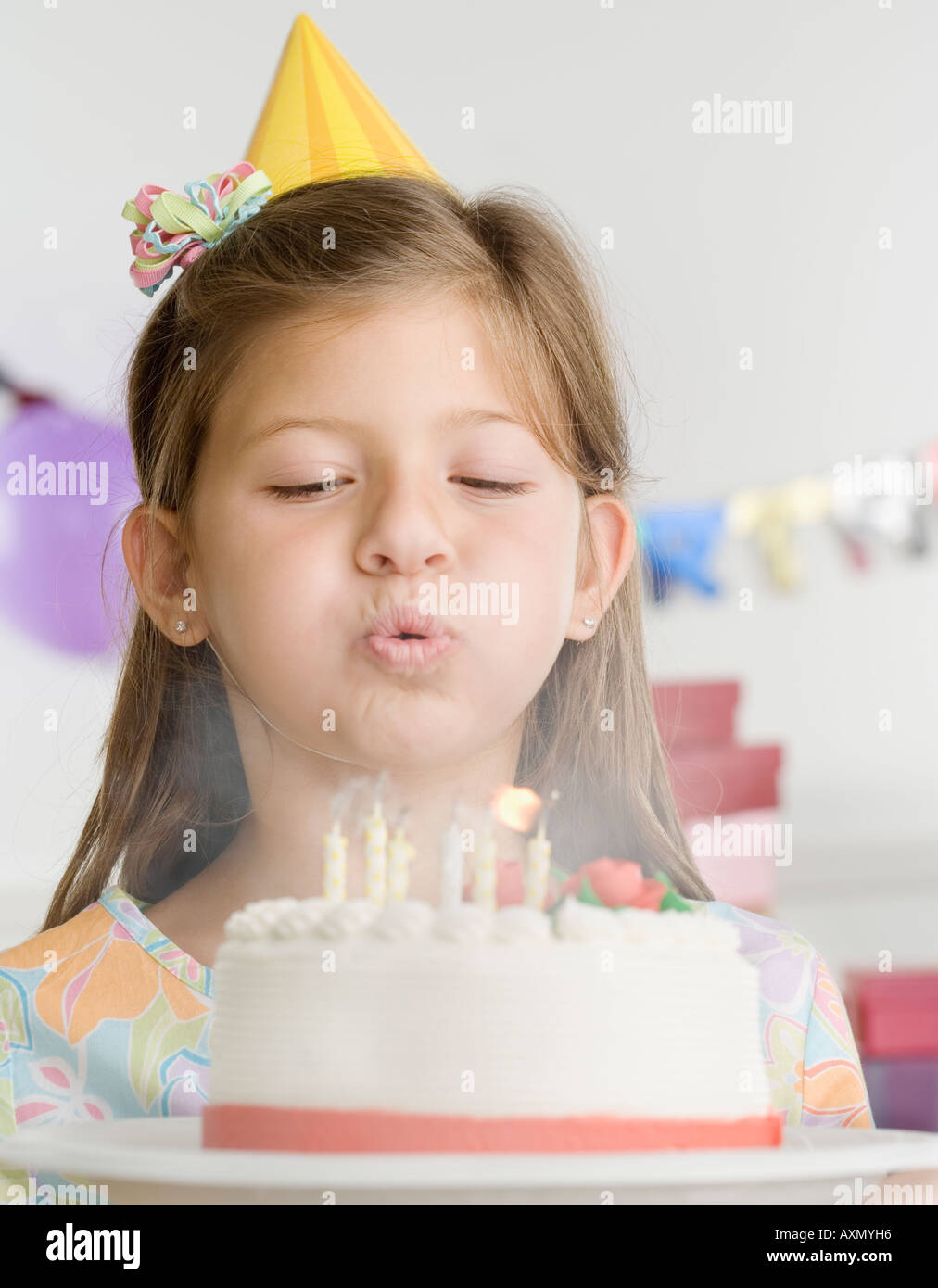 Young girl blowing out candles on cake Stock Photo Alamy