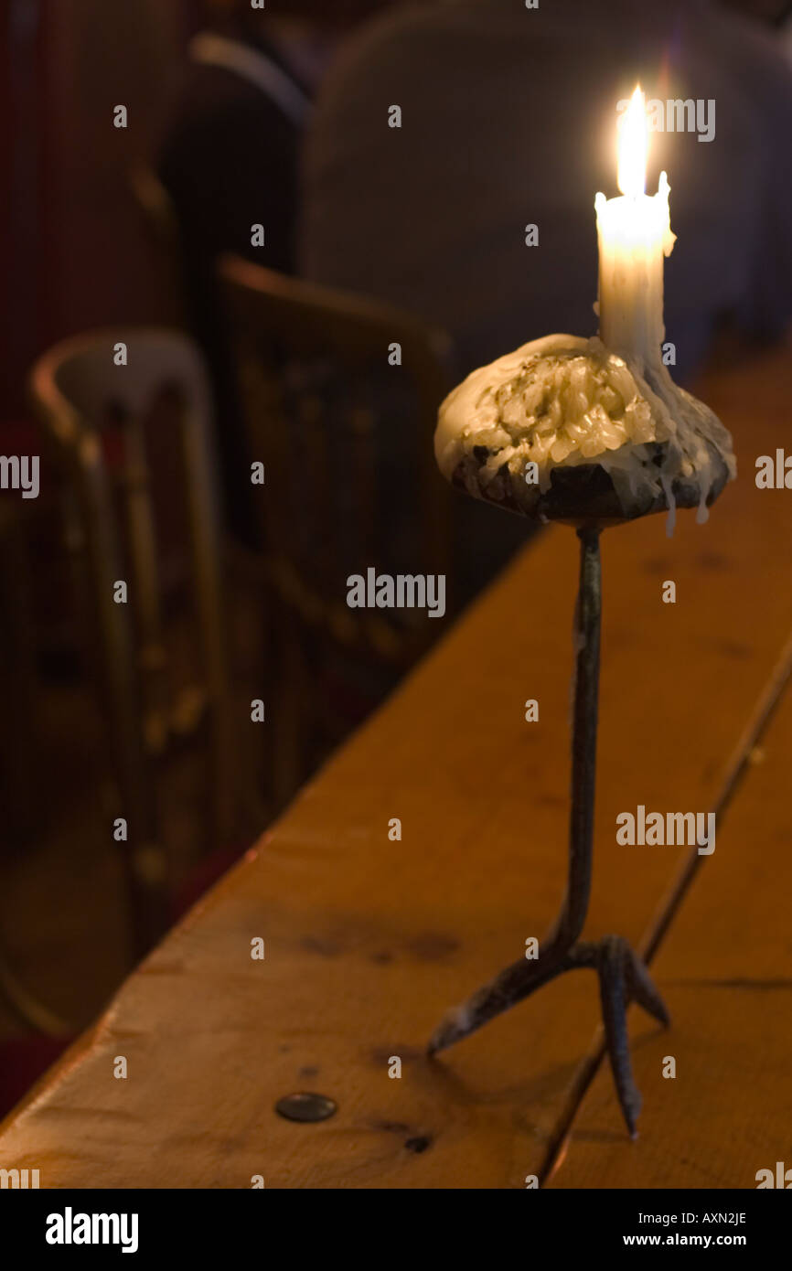 a candle dripping wax on a heavy metal candlestick Stock Photo Alamy