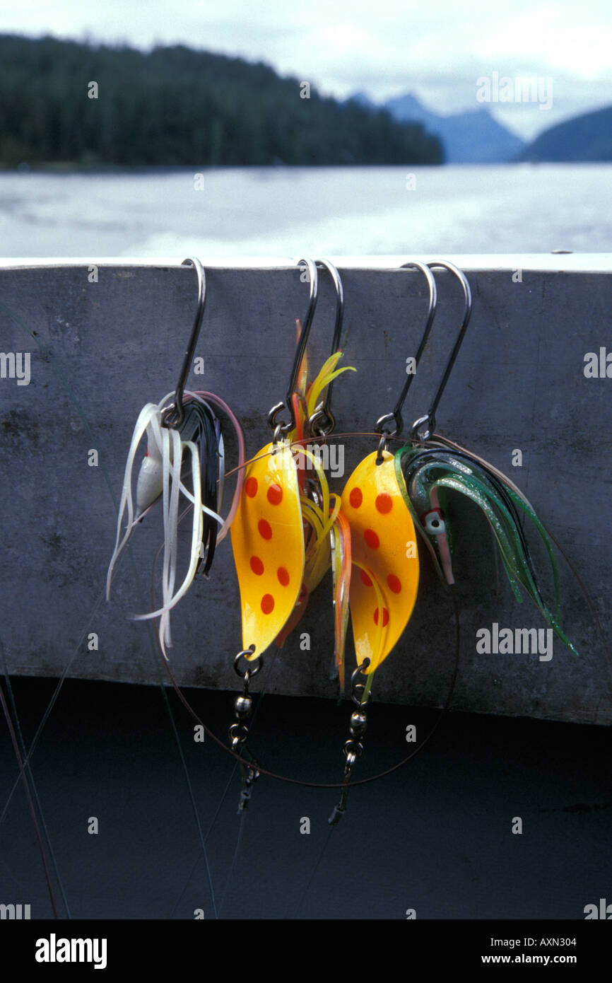An Alaskan salmon fishing boat with a closeup of colorful salmon lures with  hooks hanging on the rail Stock Photo - Alamy