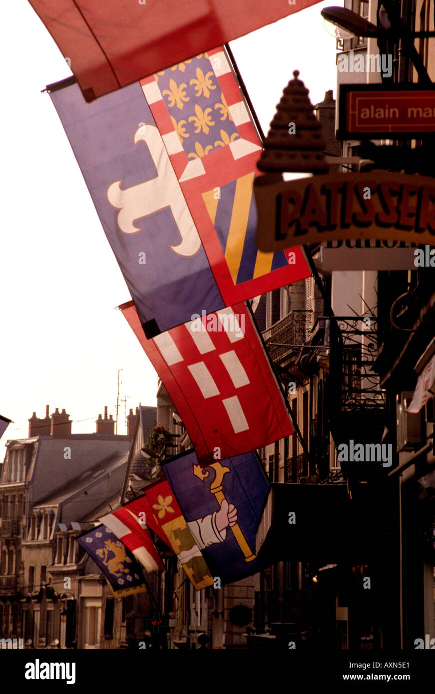 bright heraldic flags hanging in Dijon city of colourful roofs Stock Photo