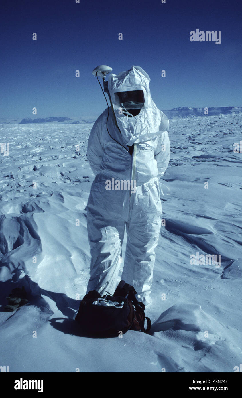 Scientist in cleansuit with Global Positioning System antenna high on Mount Melbourne Terra Nova Bay Antarctica Stock Photo