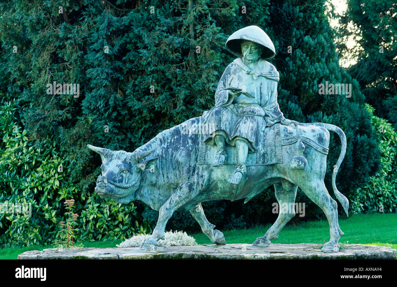 Bronze statue of ancient Chinese Taoist philosopher Lao Tzu riding an ox in Duffryn Gardens, South Glamorgan, Wales, UK Stock Photo