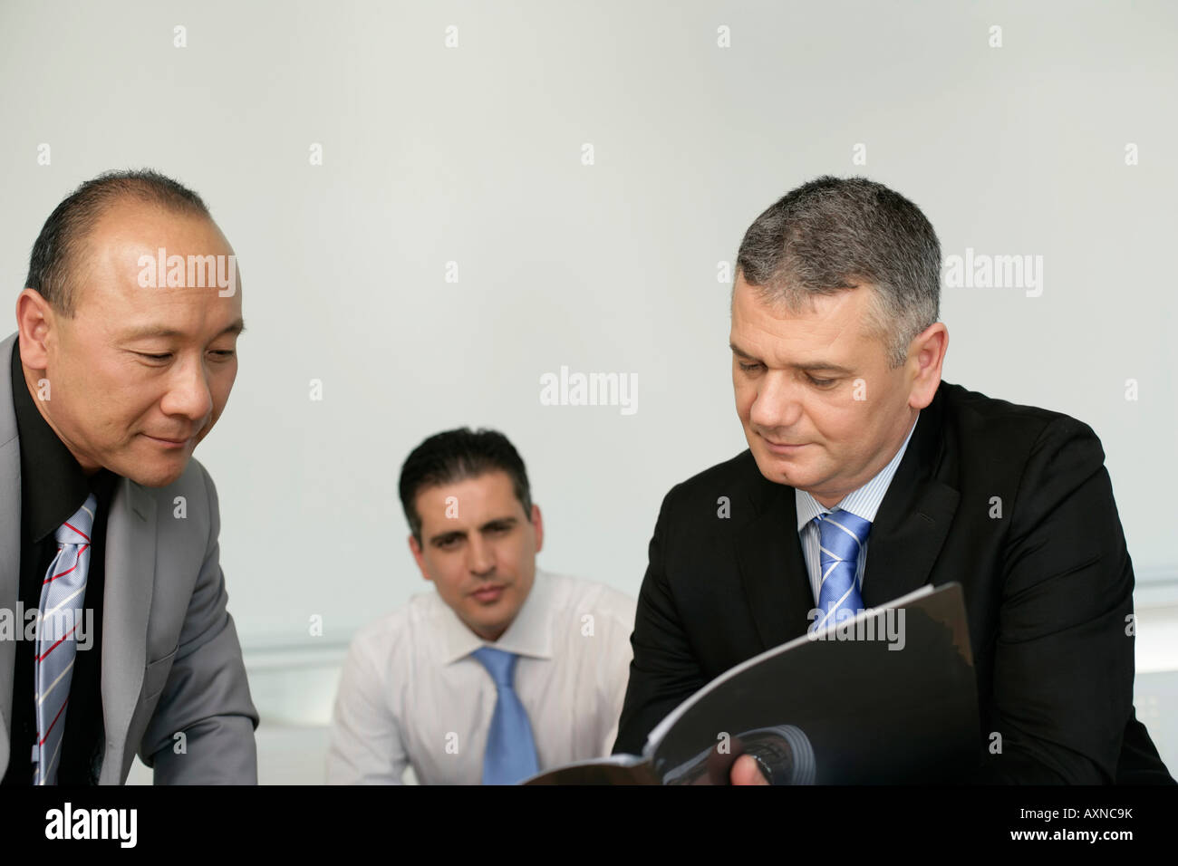 Three businessmen having a meeting Stock Photo - Alamy