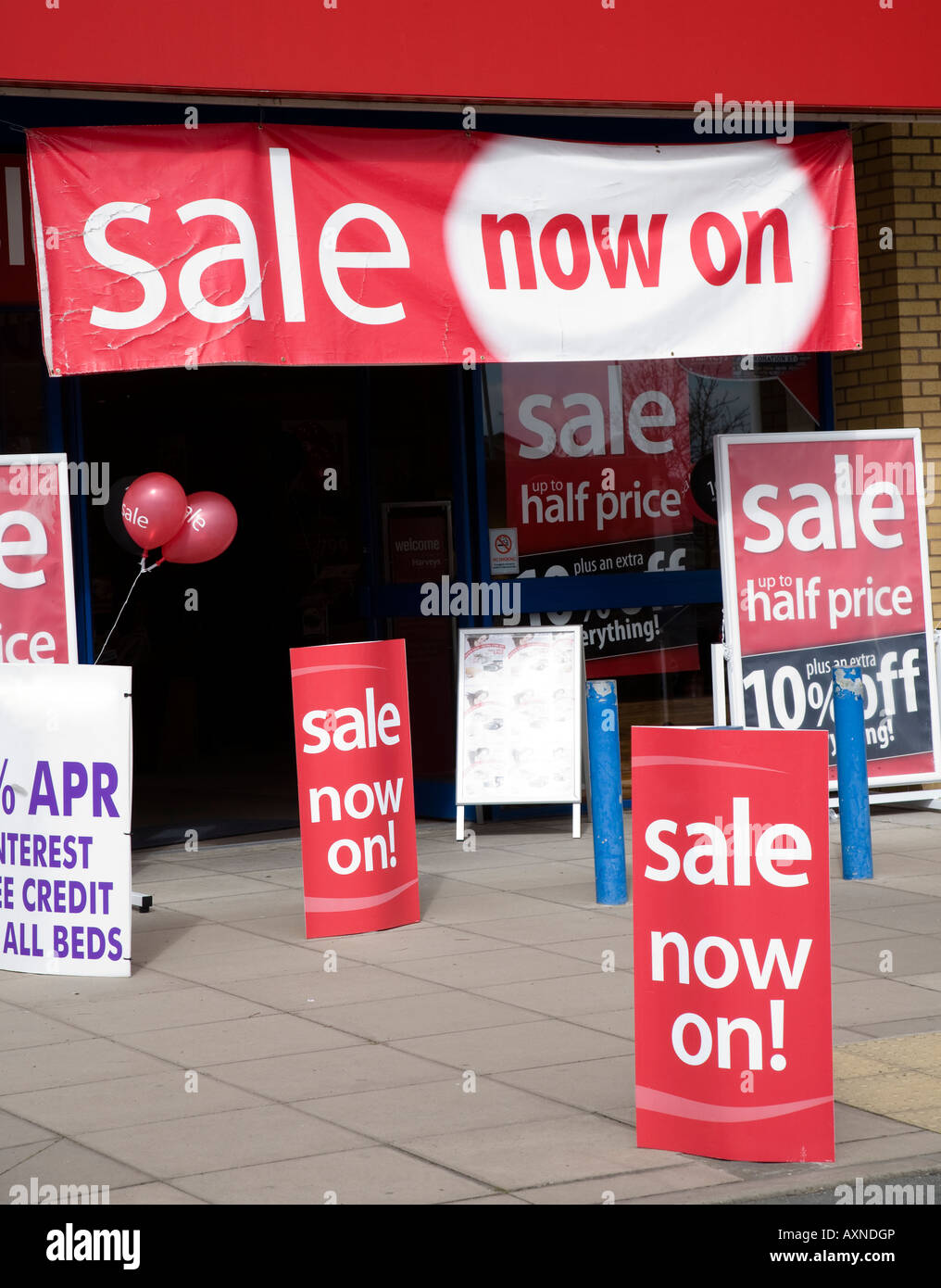 sale signs on shop entrance with store name digitally removed uk store sale signs