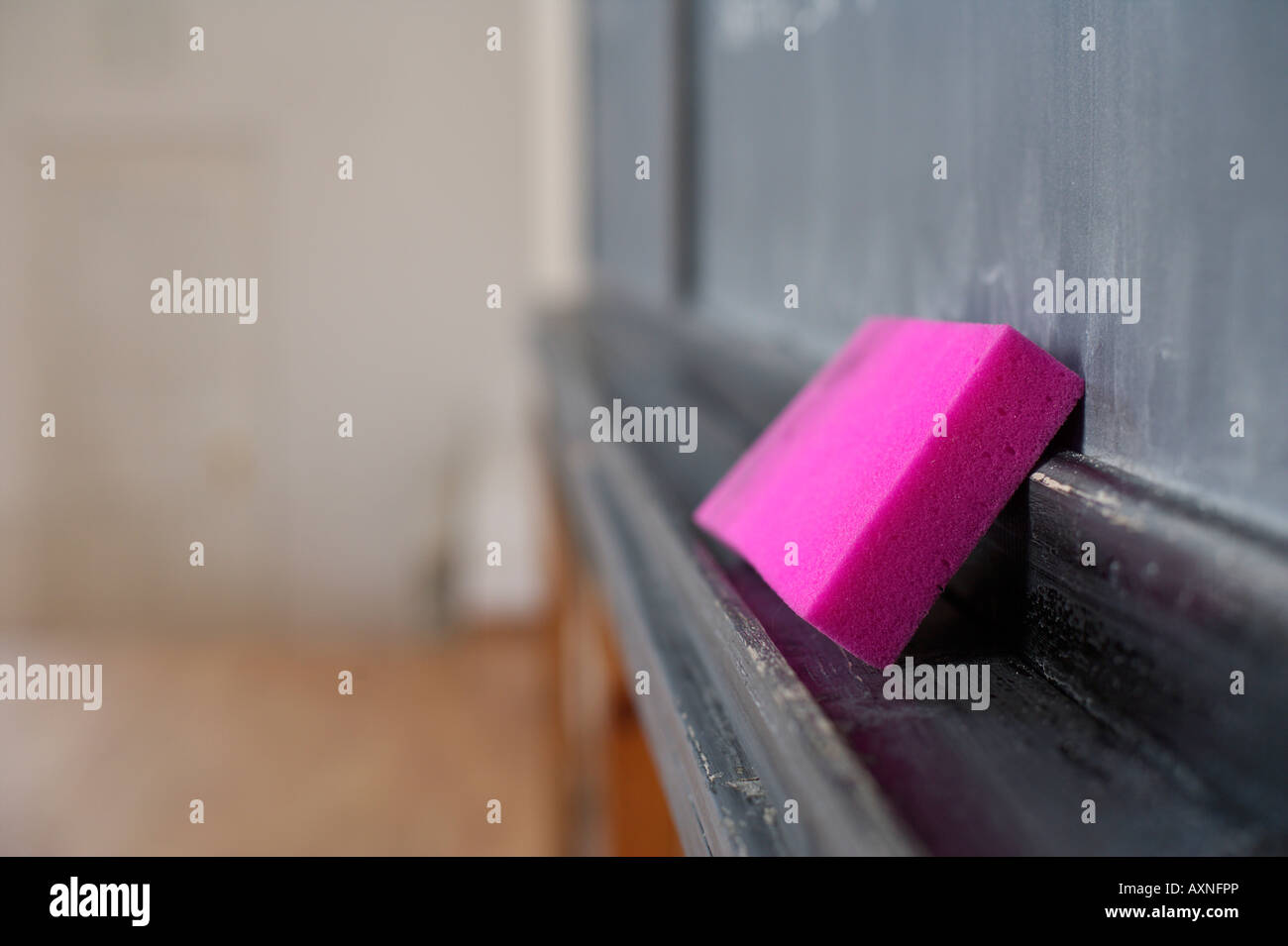 Chalk lying in front of a blackboard, selective focus Stock Photo