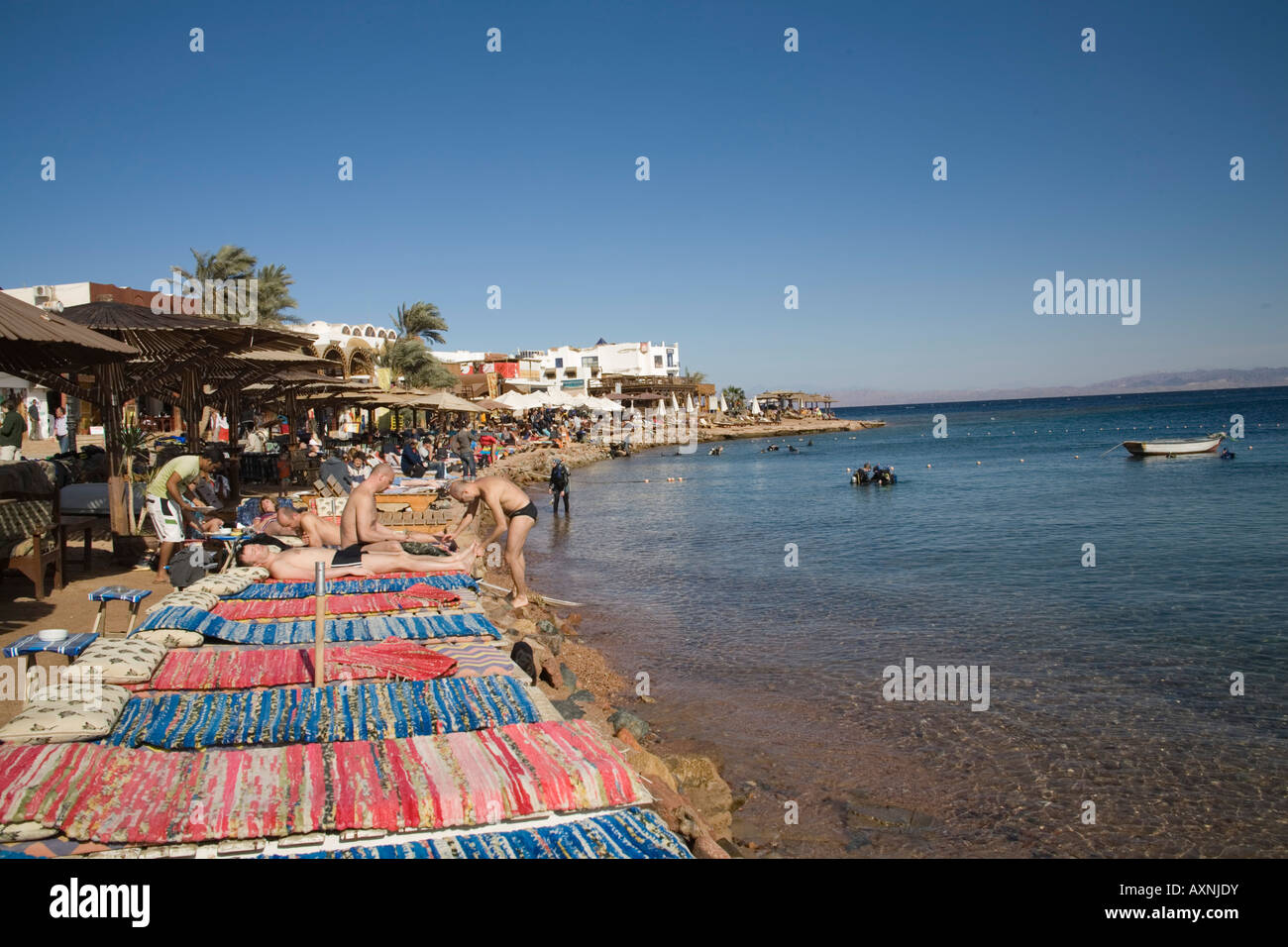 Dahab Sinai Egypt North Africa February Holiday makers sunbathing in wonderful weather in this popular diving destination Stock Photo