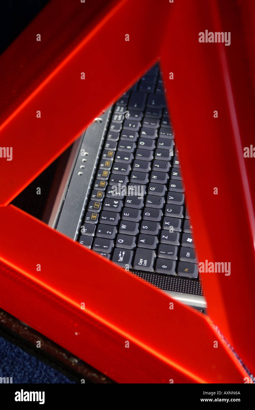 Laptop keyboard through a hazard warning triangle Stock Photo Alamy