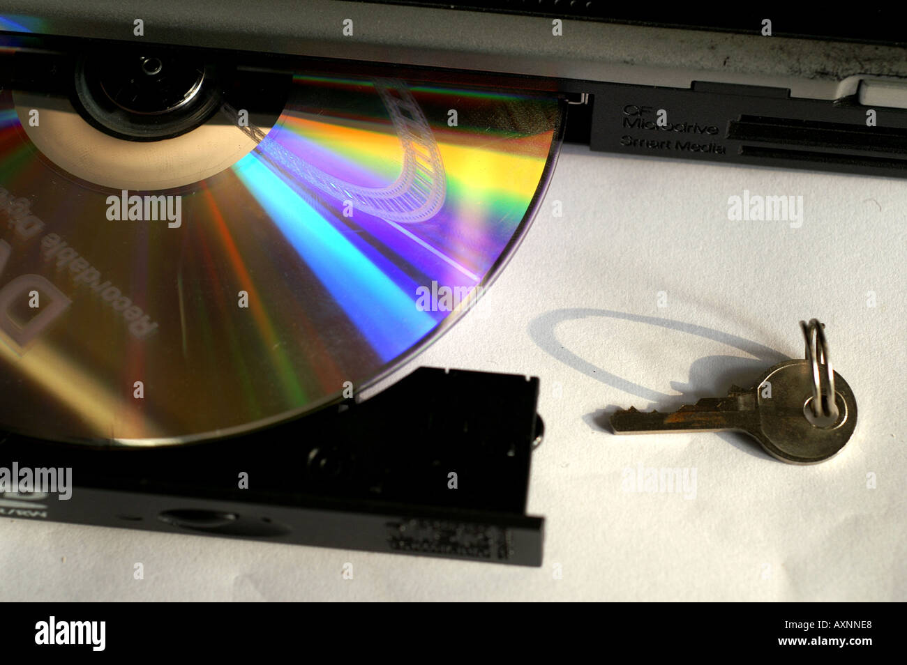 DVD on loading tray for optical reader with key Stock Photo - Alamy