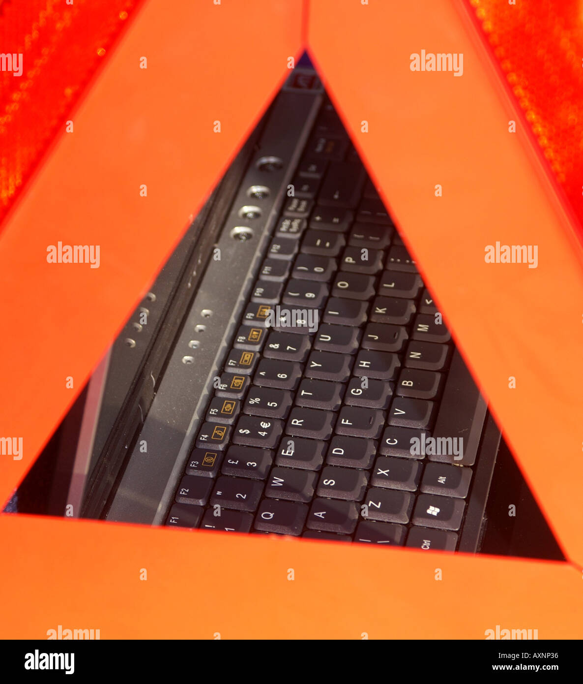 Laptop keyboard through a hazard warning triangle Stock Photo Alamy