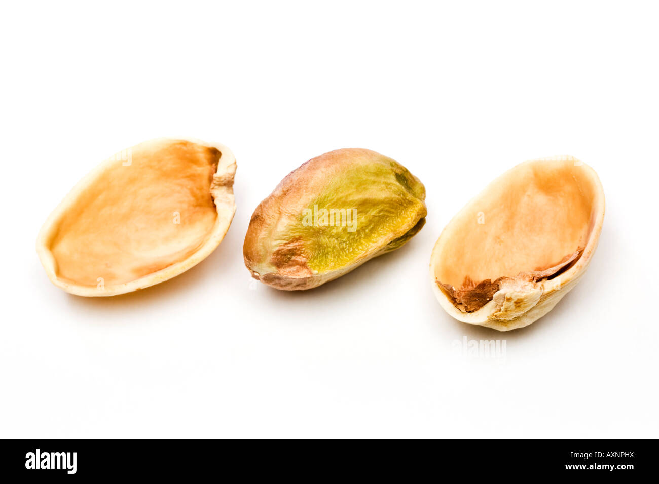 Single Pistachio nut cracked open showing shell and kernel close up