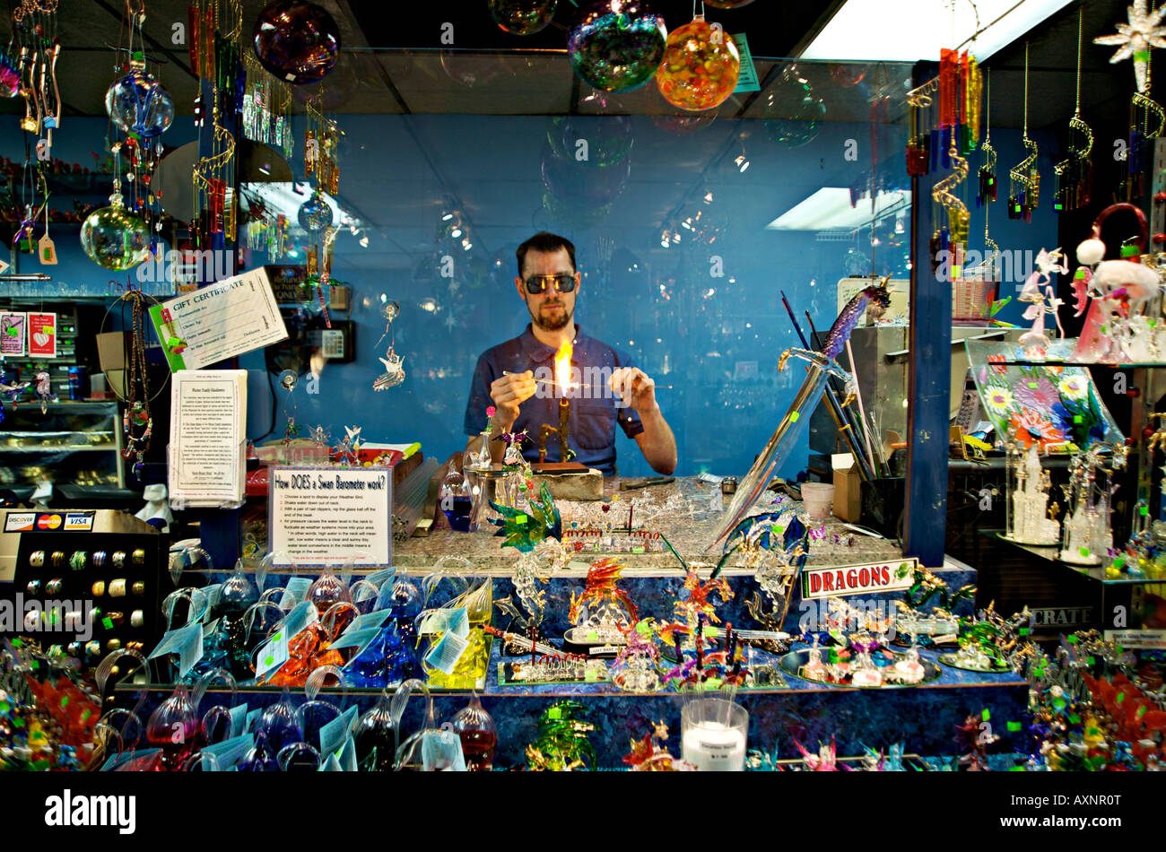 Glass blowing artist displaying his craftsmanship in a store Helen