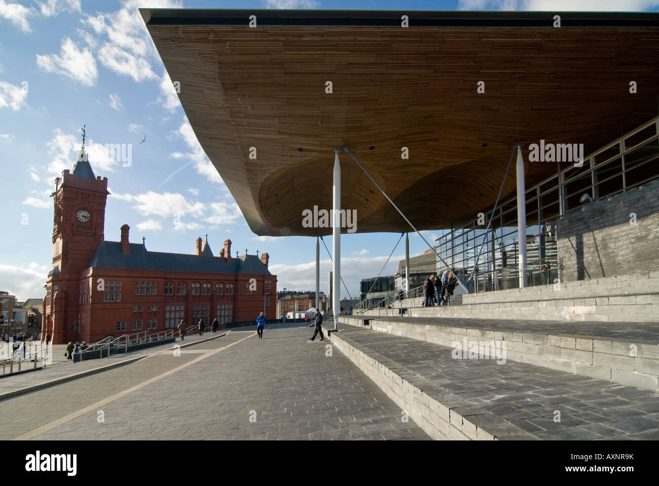 Horizontal wide angle of the modern Welsh Assembly building 'Senedd' alongside the historical grade 1 listed Pierhead Building Stock Photo