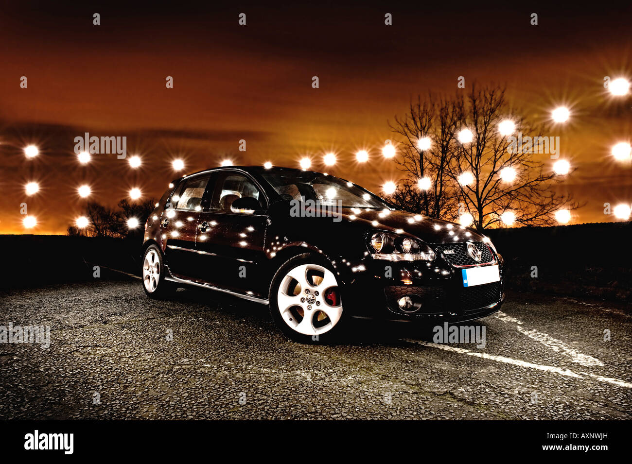 2007 Mark 5 Volkswagen VW Golf GTi Turbo black at night lit by flash speedlight at  sunset five door Stock Photo