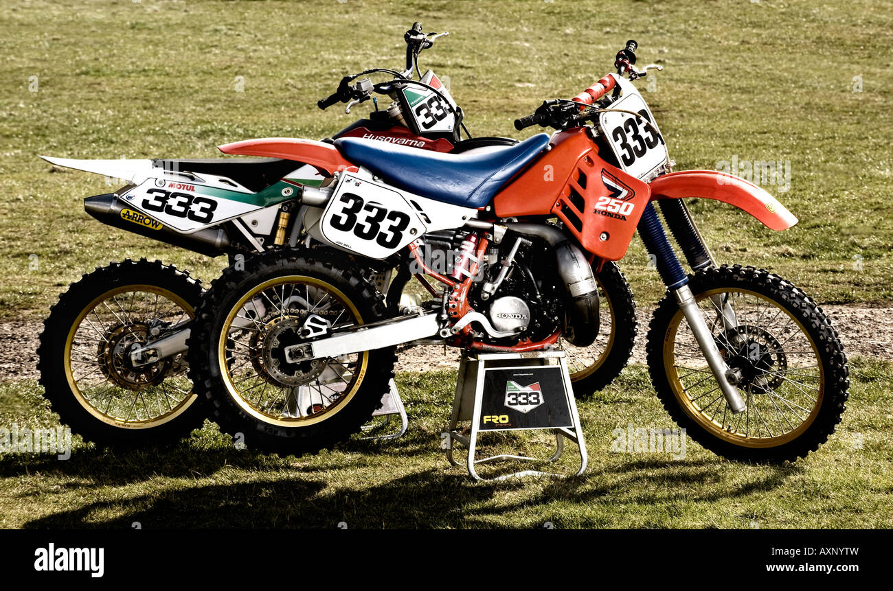 1987 Honda CR250R motocross dirt bike with 2006 Husqvarna TC450 four-stroke dirt bike Stock Photo